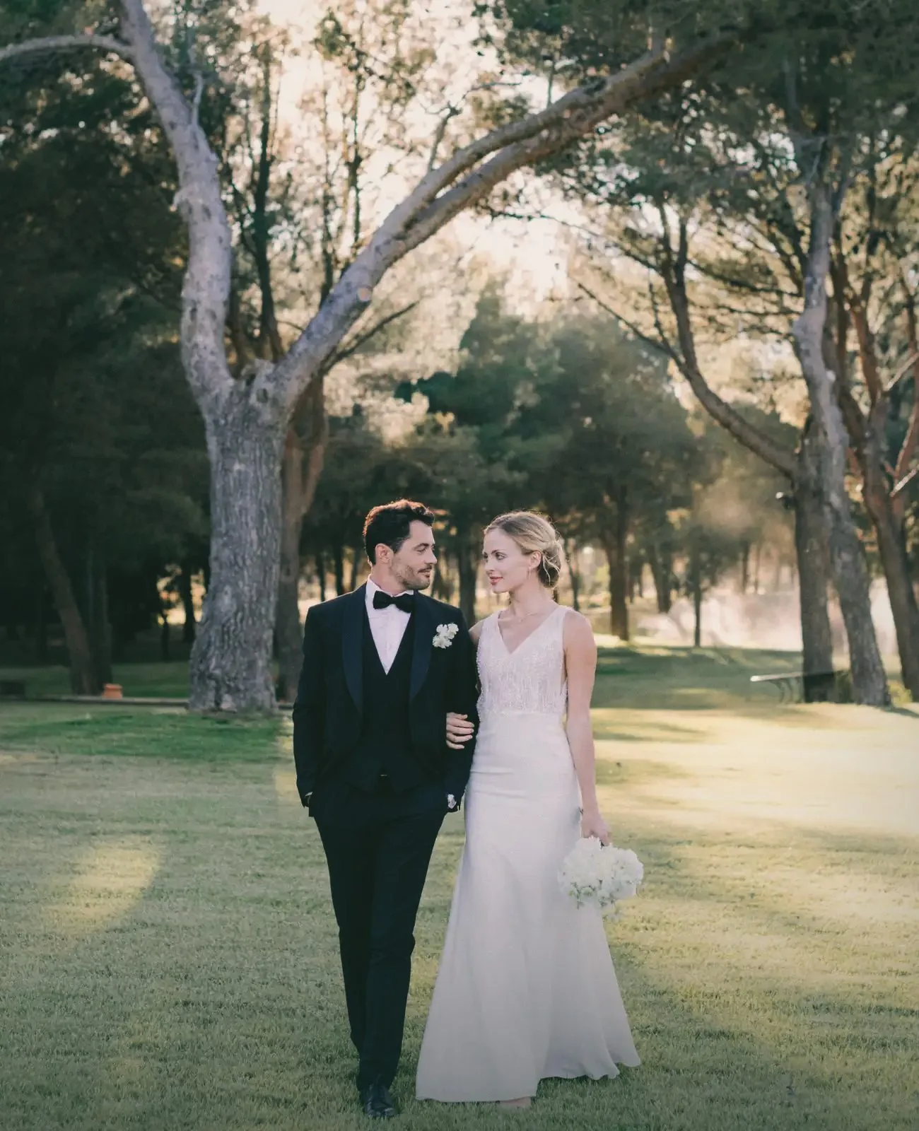 A couple walking together under the trees